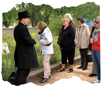 Dressed as a historical doctor, Kristen explains Winnipeg's history on a walking tour outdoors